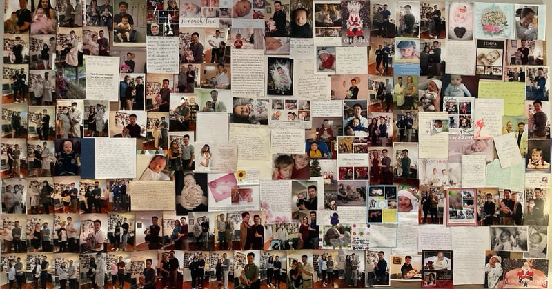 The baby wall at Dr. Ye's clinic, covered in thank you cards, baby photos, and letters from clients